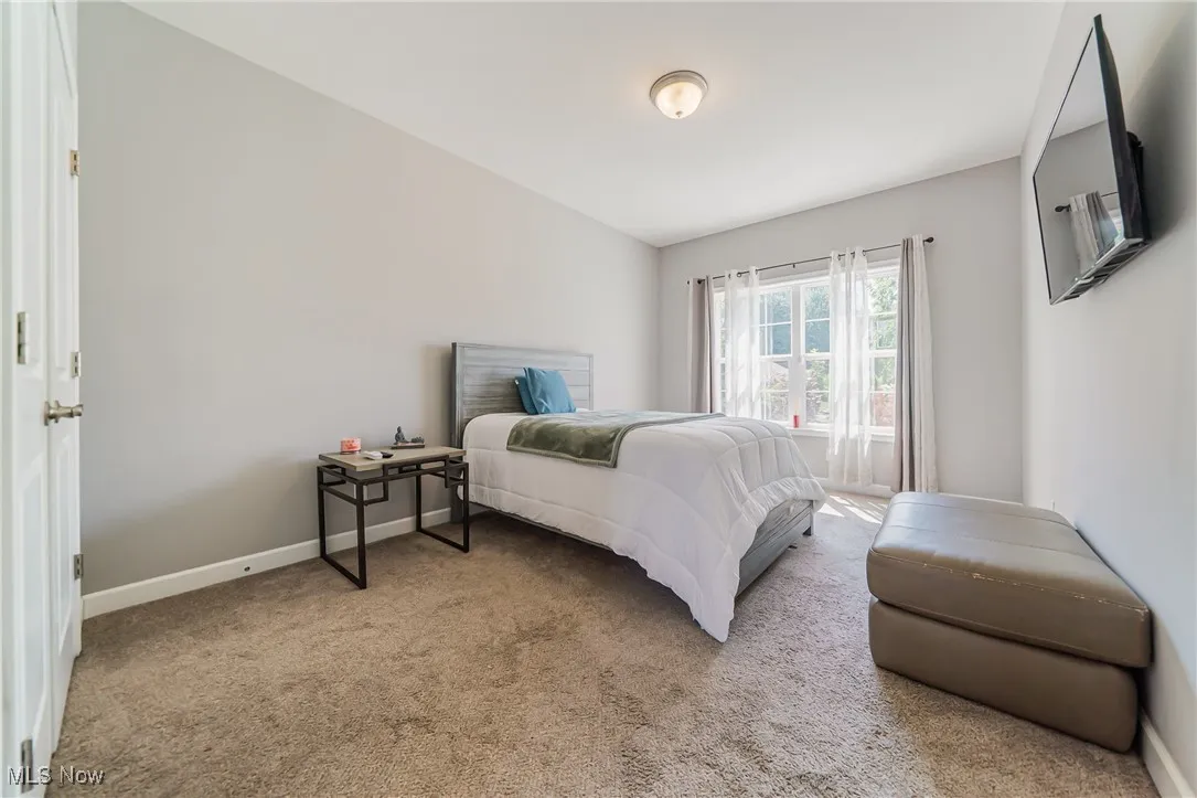 Carpeted bedroom with baseboards