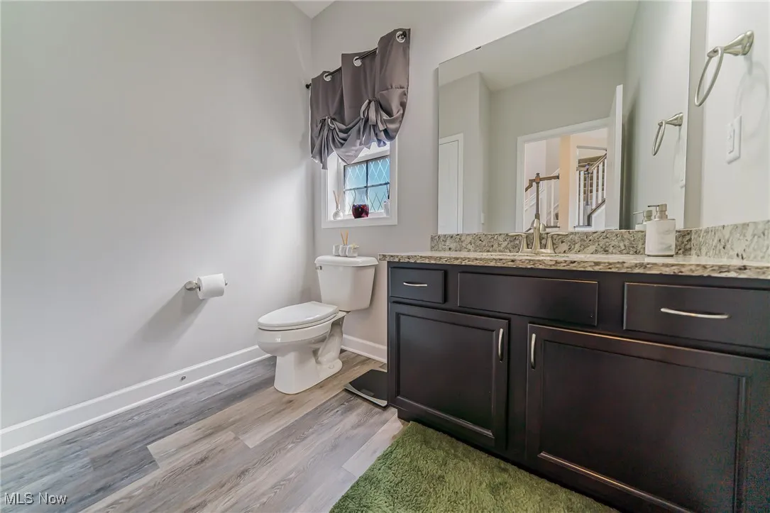Bathroom featuring vanity and wood finished floors