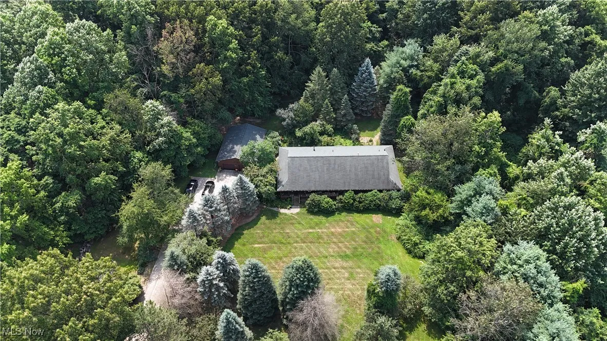 View of subject property with a forest