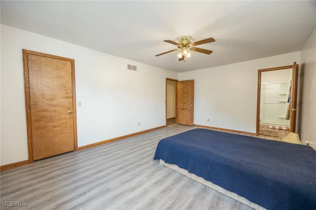 Unfurnished bedroom featuring wood finis