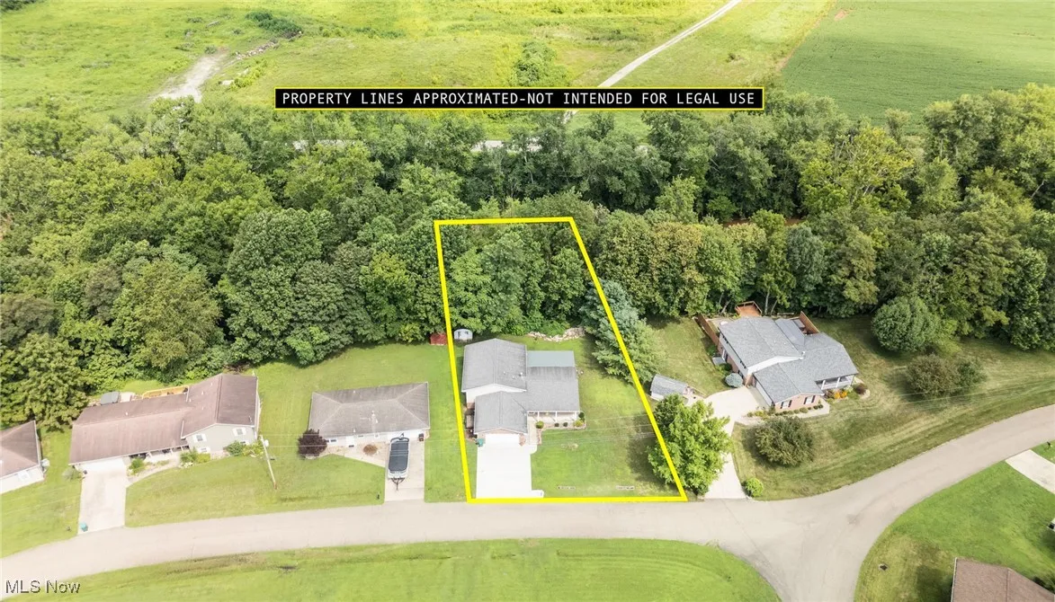 Aerial view of property and surrounding area with property parcel outlined