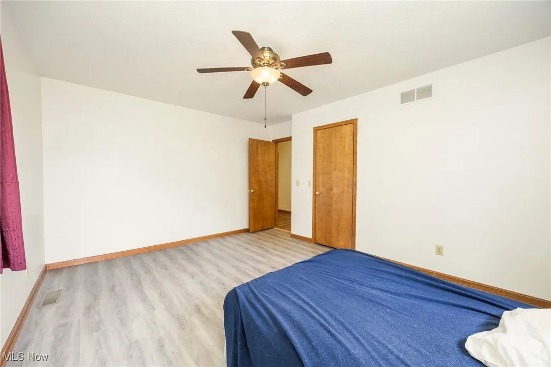 Bedroom, ceiling fan, and a closet