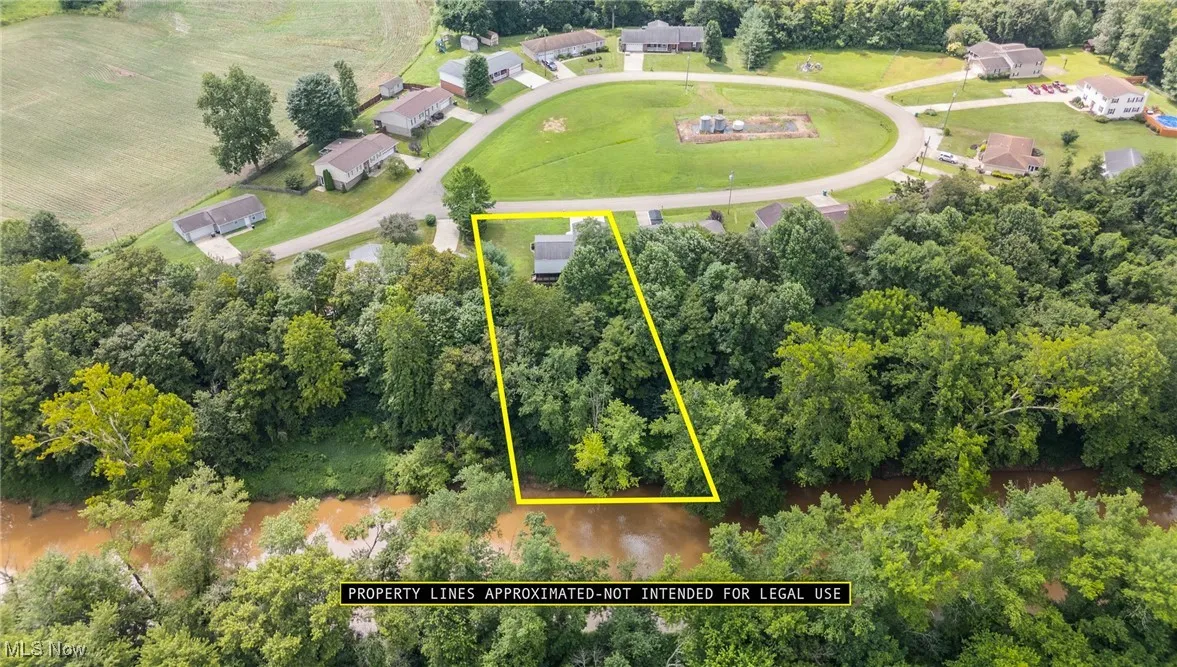 Aerial view of property's location with property boundaries highlighted and a tree filled landscape