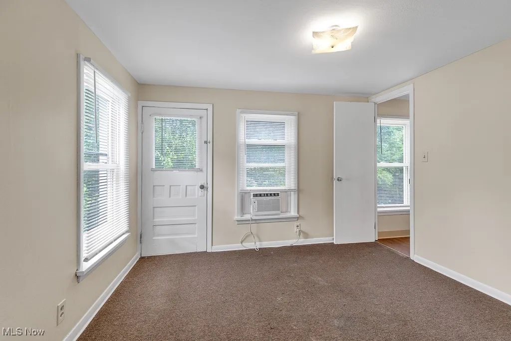 Entryway with carpet floors and baseboards