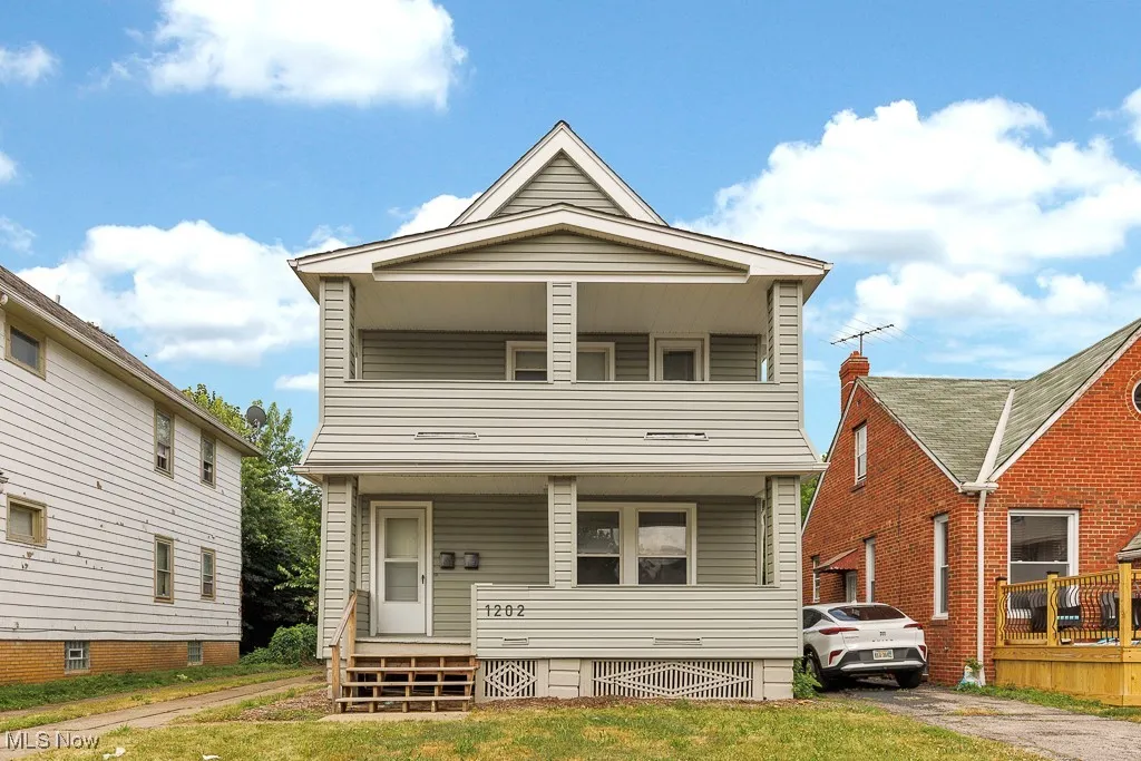 View of front of house with covered porch and a balcony