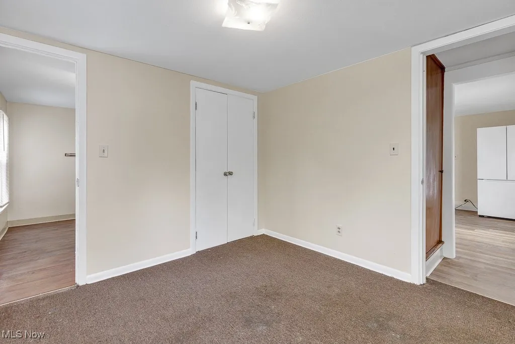 Unfurnished bedroom with carpet flooring and a closet