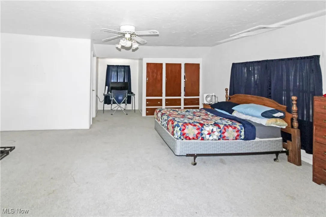 Bedroom with carpet flooring and a ceiling fan