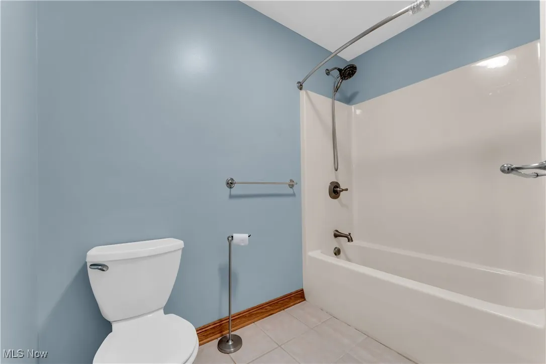 Full bath with shower / bathtub combination and tile patterned flooring