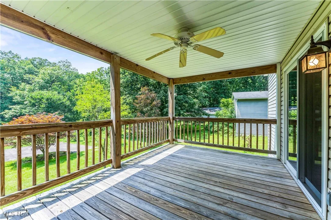 Deck featuring a ceiling fan off two of the bedrooms