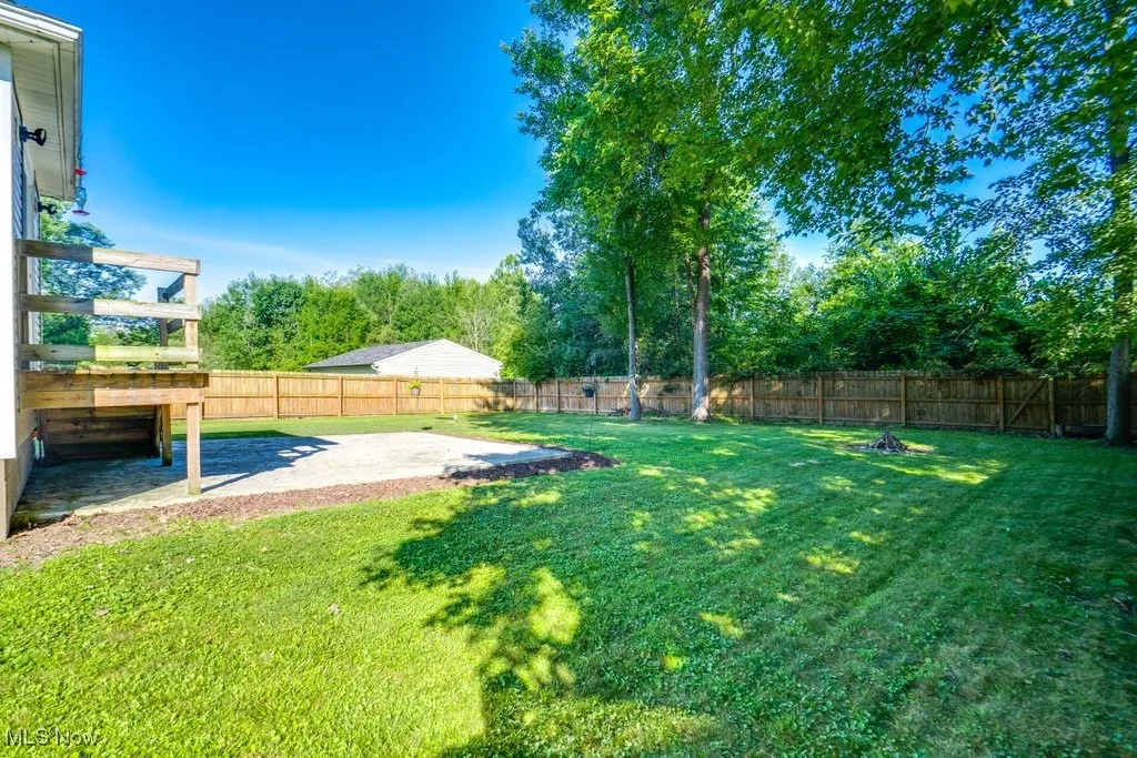 Fenced backyard featuring a patio