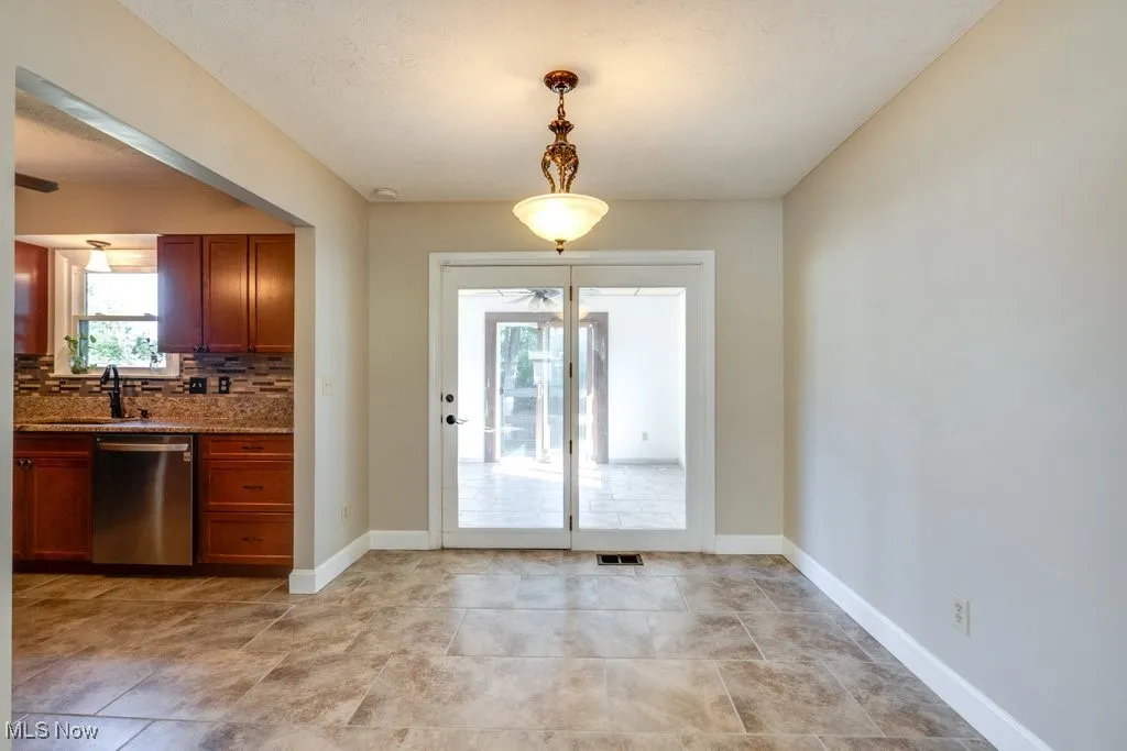 Entryway featuring baseboards and a sink