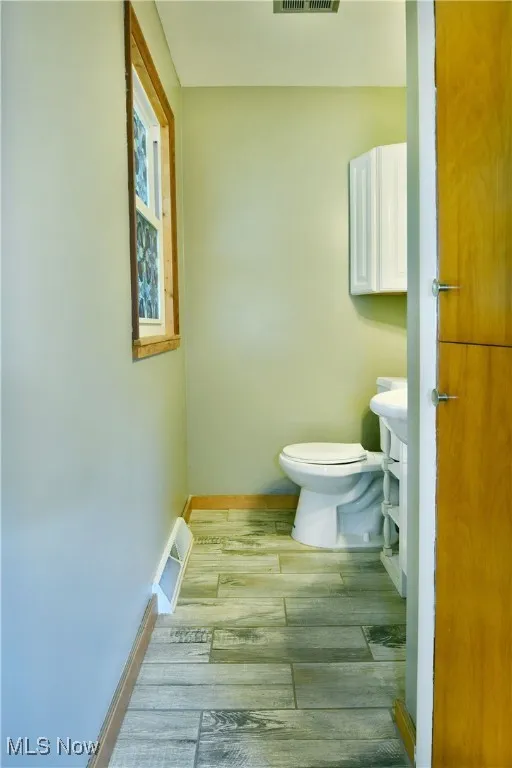 Bathroom featuring wood finished floors and baseboards