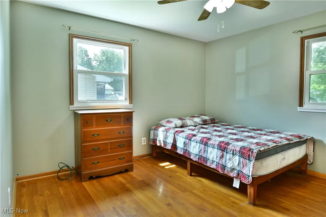 Bedroom featuring wood finished floors and ceiling fan