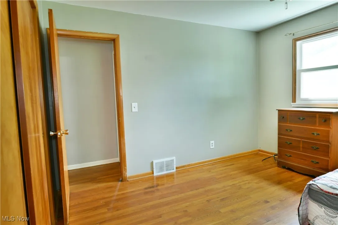 Bedroom featuring light wood-type flooring and baseboards
