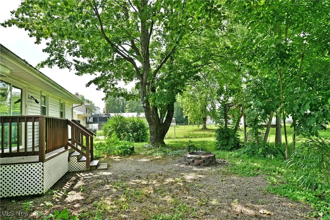 View of yard featuring a fire pit and a wooden deck