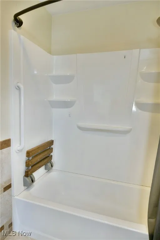 Full bath featuring bathtub / shower combination