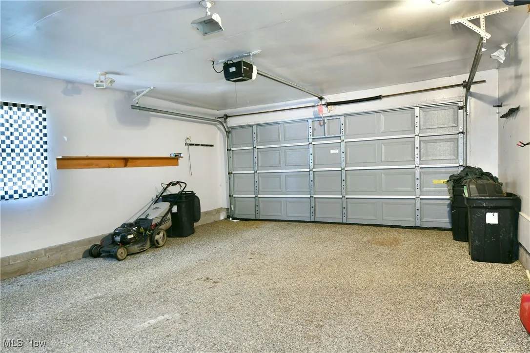 Garage featuring a garage door opener