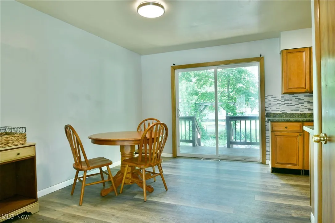Dining room featuring light wood finished floors and baseboards