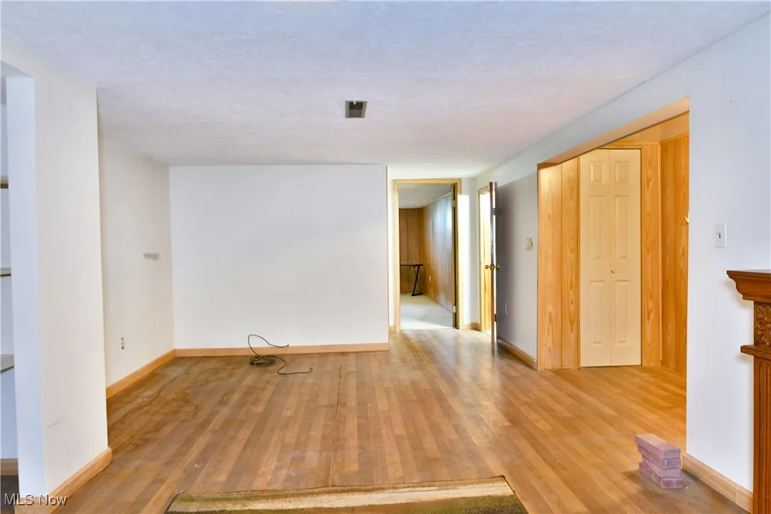 Unfurnished room featuring wood finished floors and baseboards