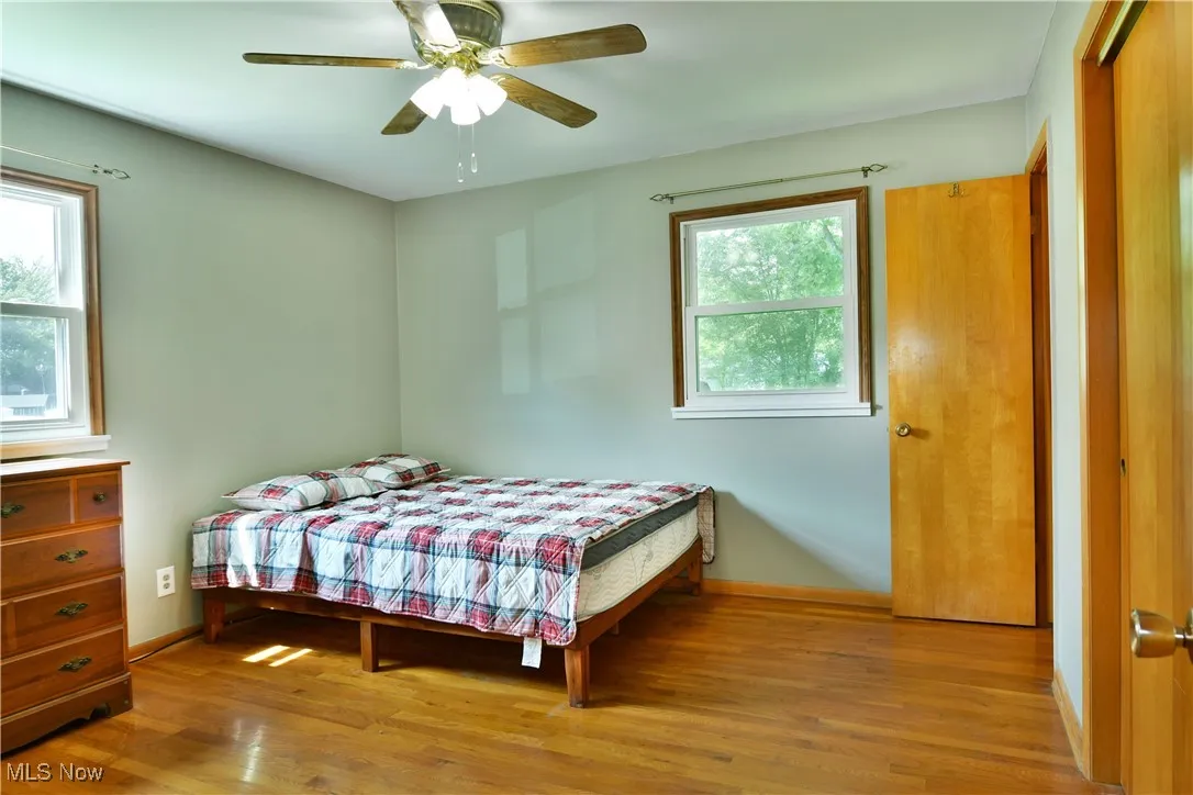 Bedroom with wood finished floors and ceiling fan
