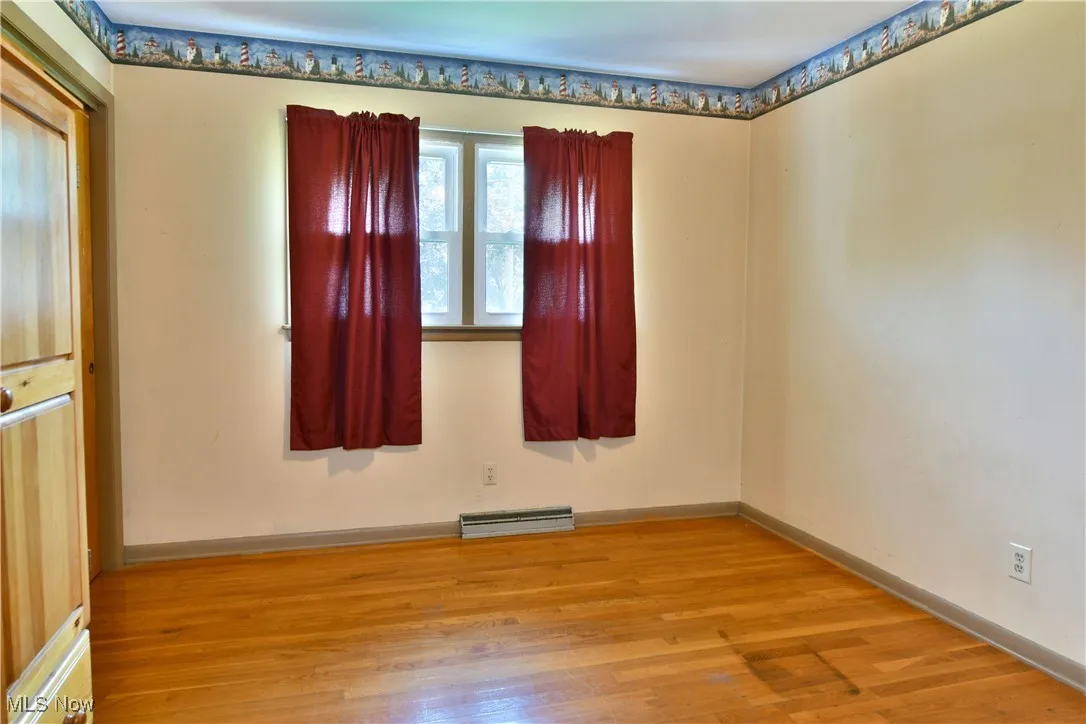 Spare room with wood finished floors