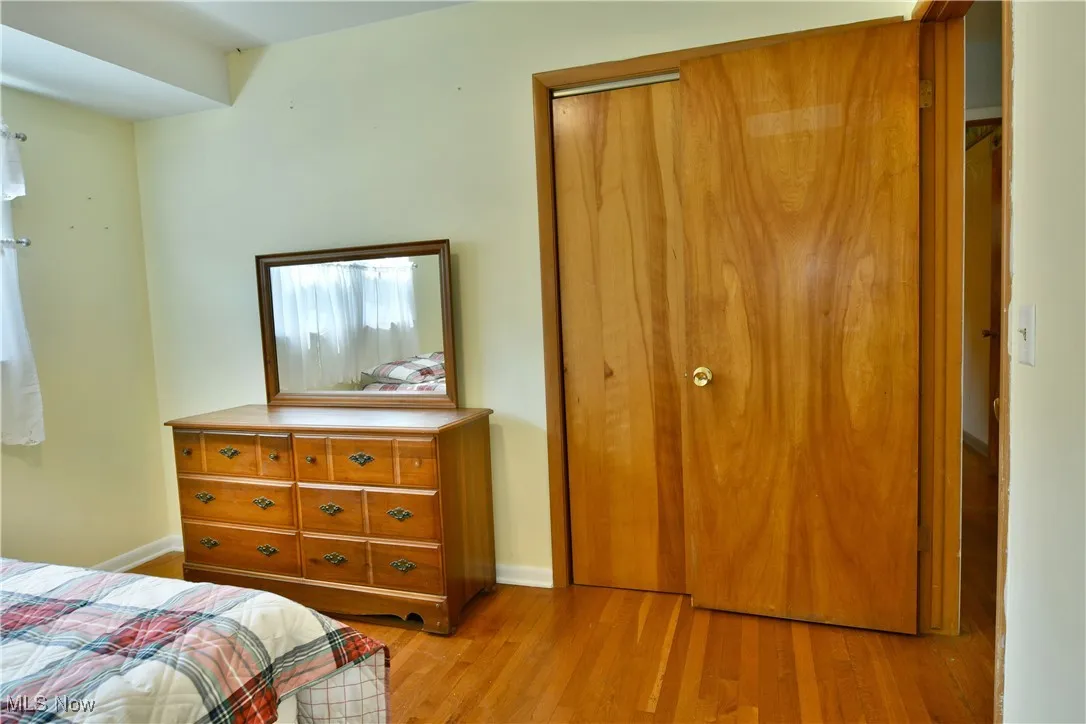 Bedroom featuring light wood finished floors and baseboards