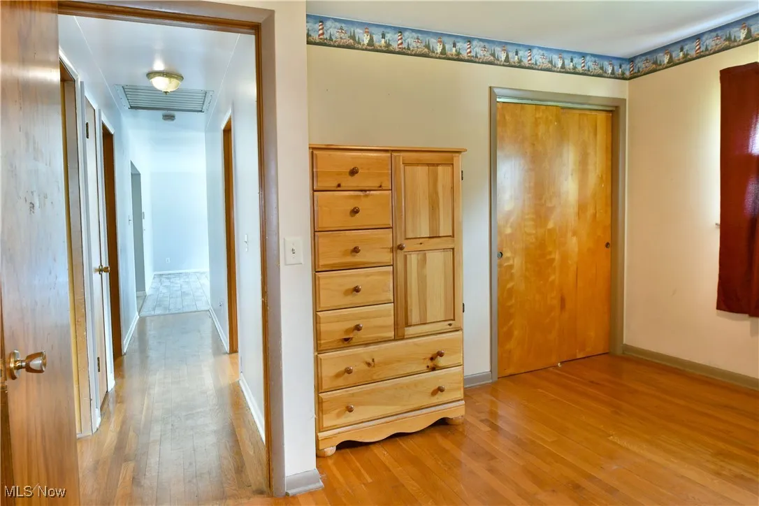Hallway featuring light wood-style floors