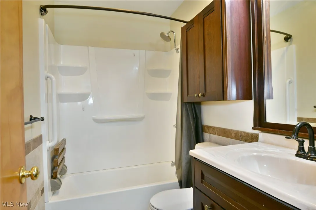 Bathroom featuring vanity and shower / tub combo