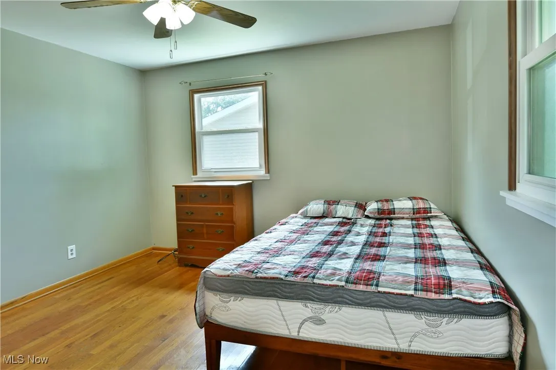 Bedroom featuring wood finished floors and a ceiling fan