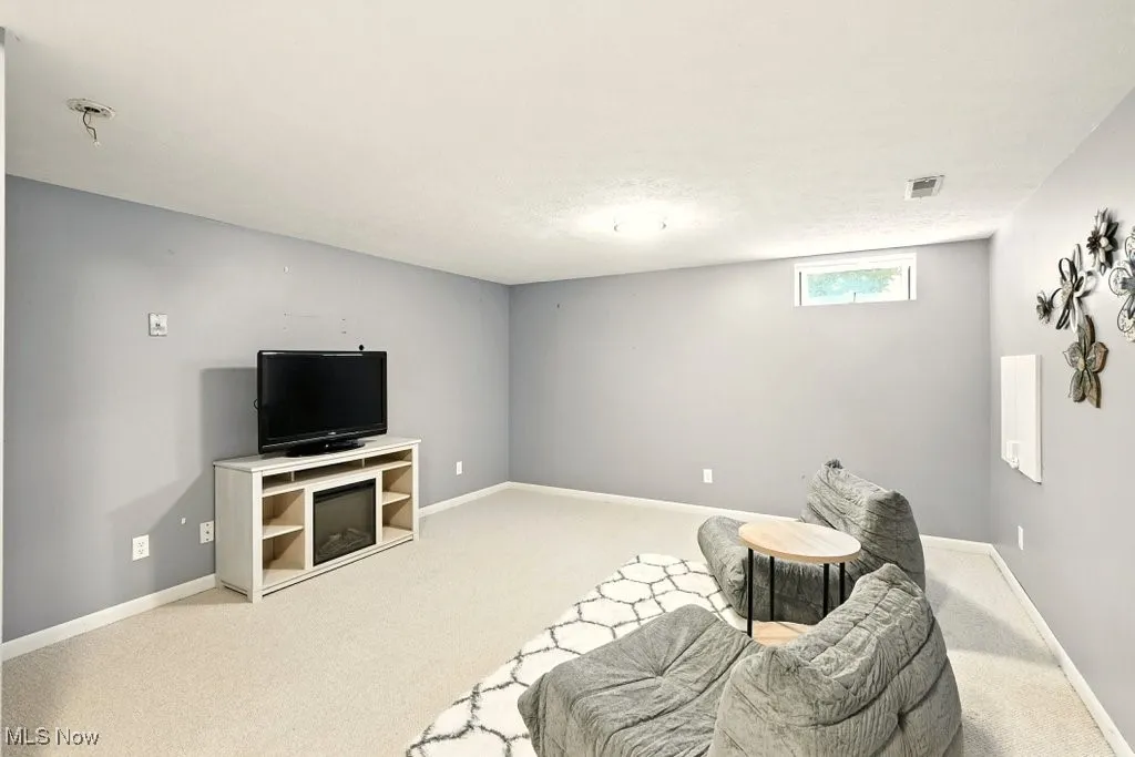 Living area with carpet floors and baseboards