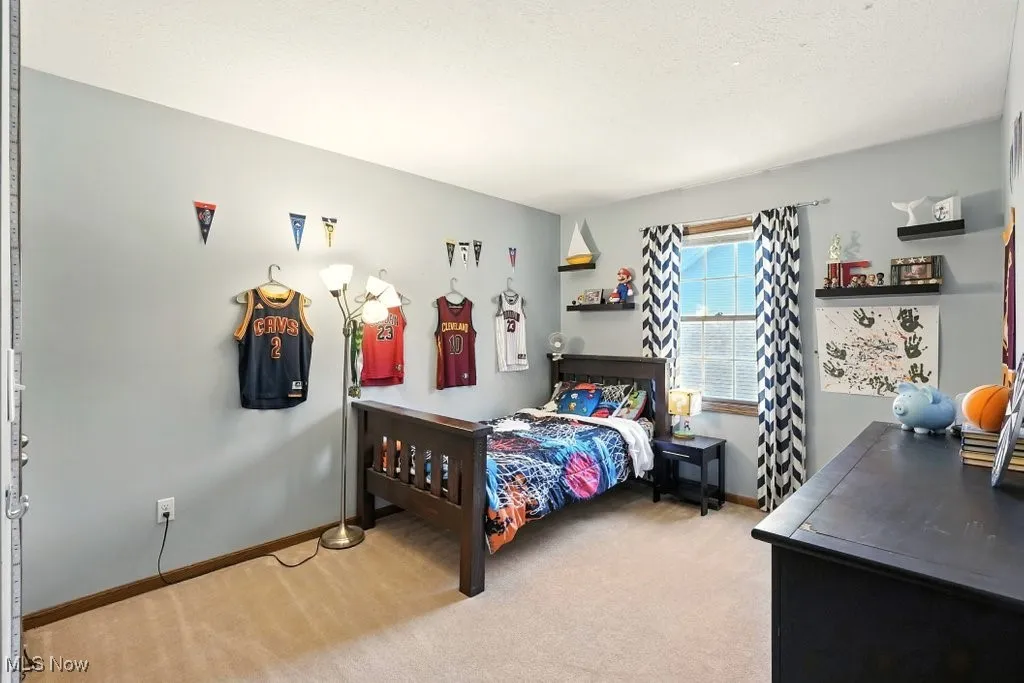 Bedroom with carpet flooring and baseboards