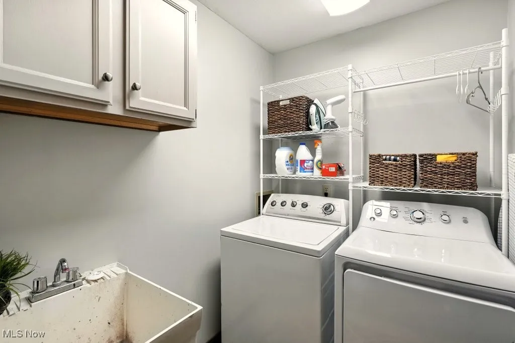 Laundry area with independent washer and dryer and cabinet space
