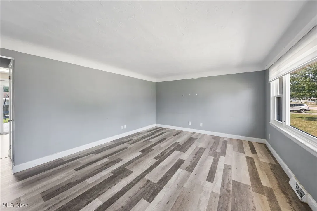 Empty room with wood finished floors and baseboards