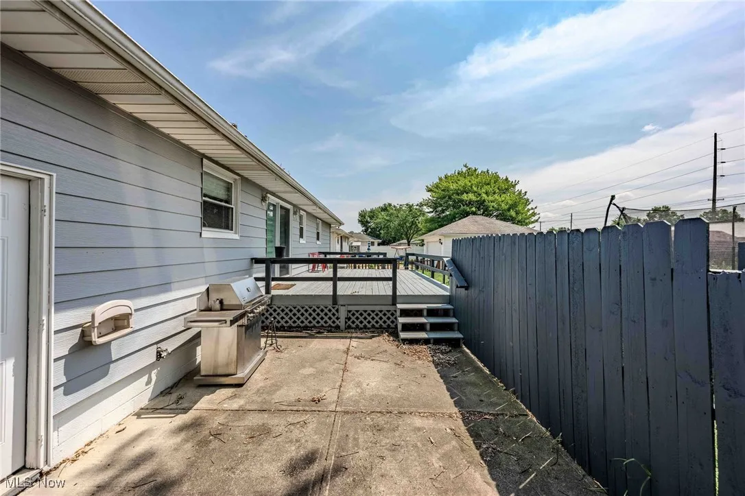 View of patio featuring a deck and a grill