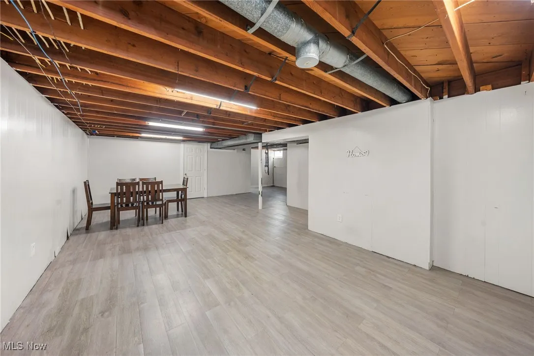 Finished below grade area with light wood-type flooring