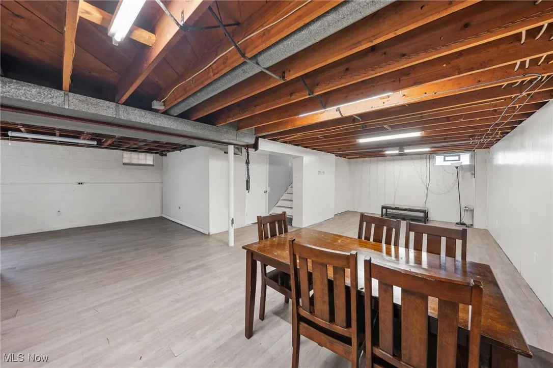 Dining room with stairway and light wood finished floors