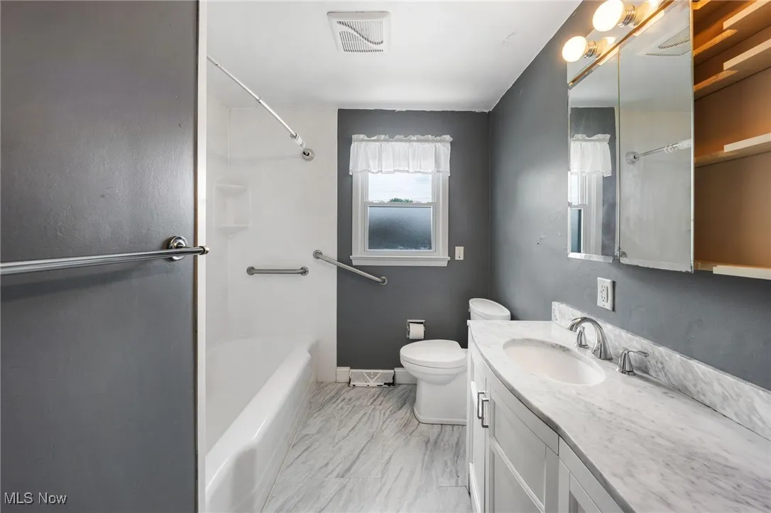 Bathroom featuring vanity and bathtub / shower combination
