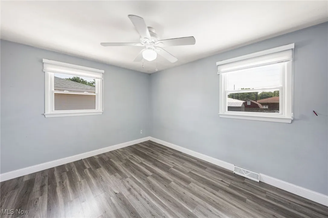 Unfurnished room with wood finished floors and ceiling fan