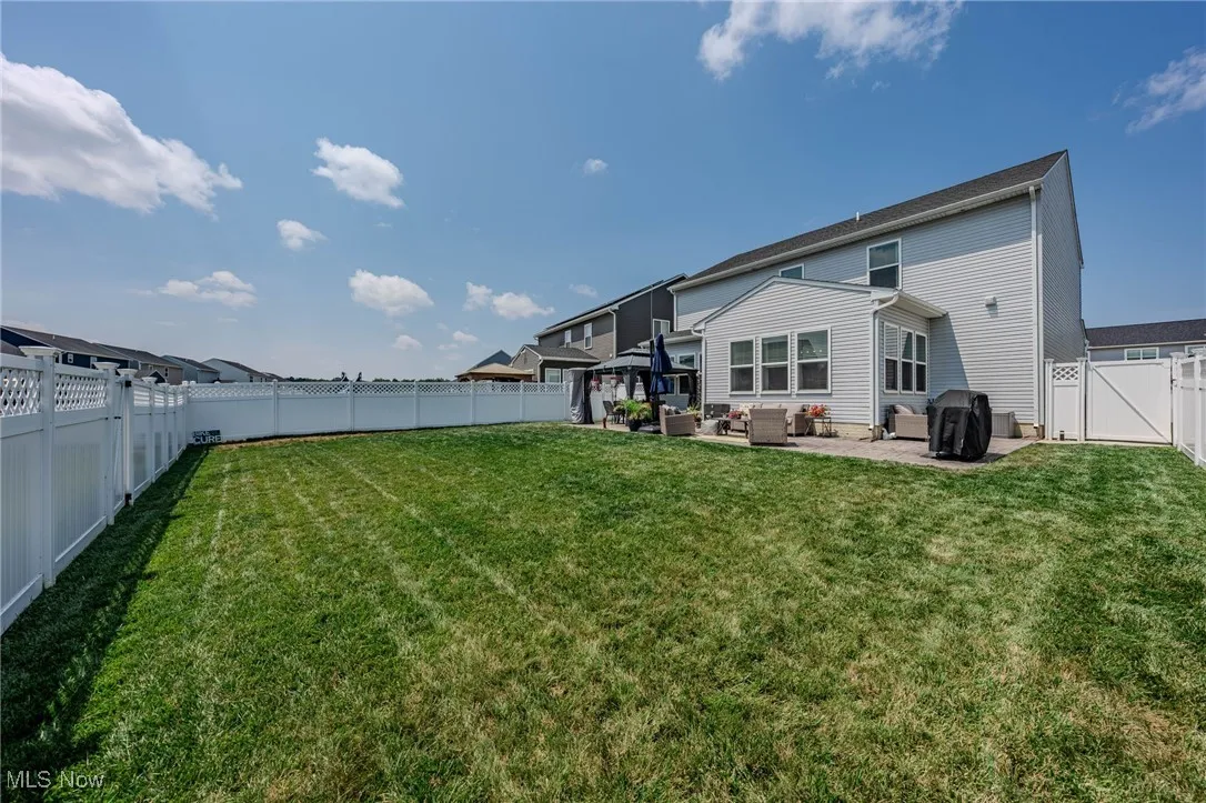 Back of house with outdoor lounge area, a patio area, a gate, and a fenced backyard