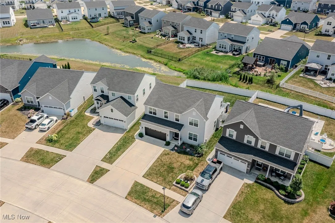 Aerial view of residential area featuring a nearby body of water