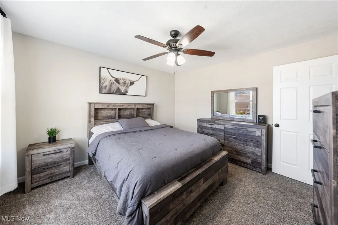 Bedroom with carpet and a ceiling fan