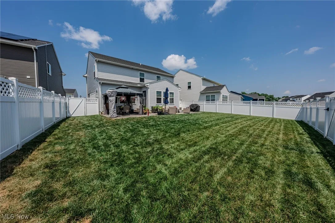 Back of house featuring a gazebo, an outdoor hangout area, a fenced backyard, and a patio area