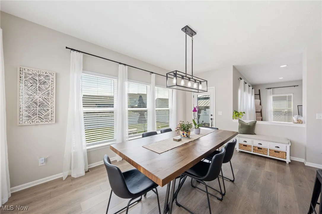 Dining area with wood finished floors, plenty of natural light, and recessed lighting