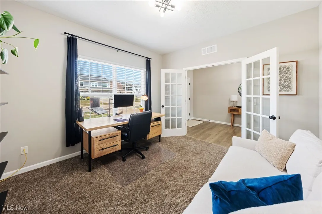 Home office featuring french doors and baseboards