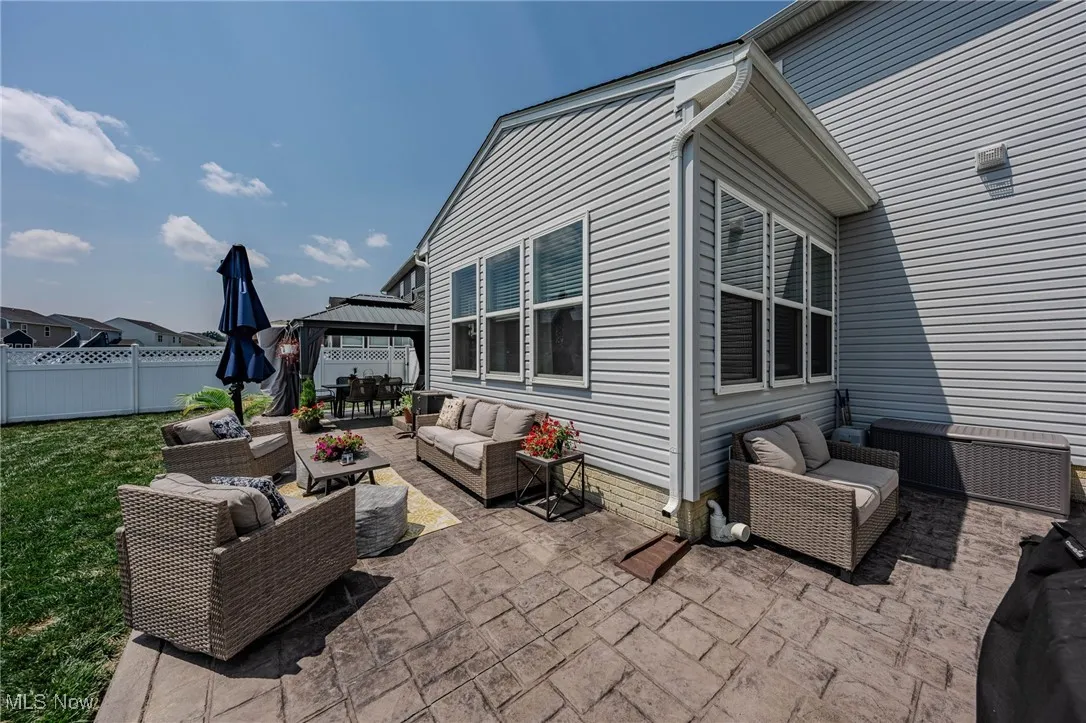 View of patio with an outdoor hangout area and a gazebo