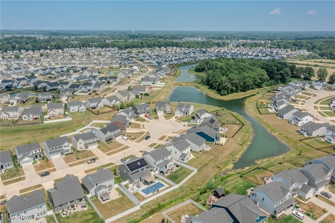 View of property location featuring a nearby body of water and nearby suburban area