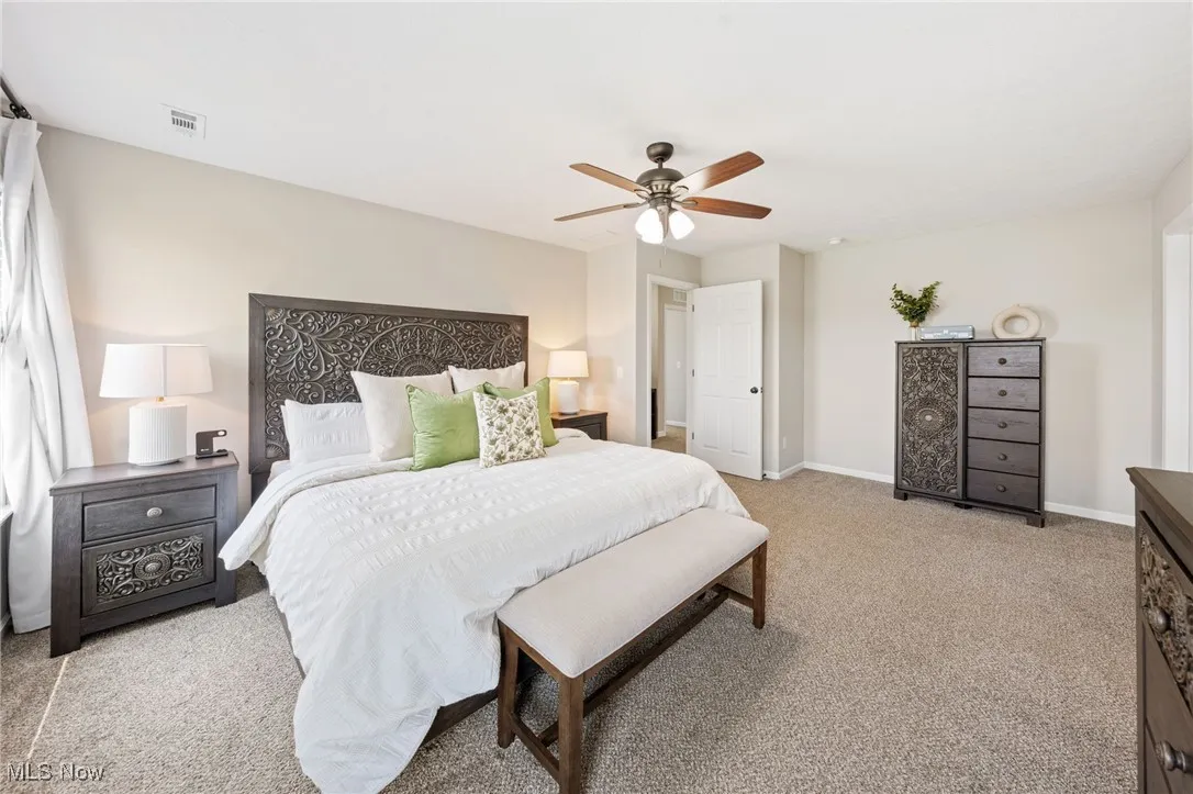 Bedroom featuring light carpet and a ceiling fan