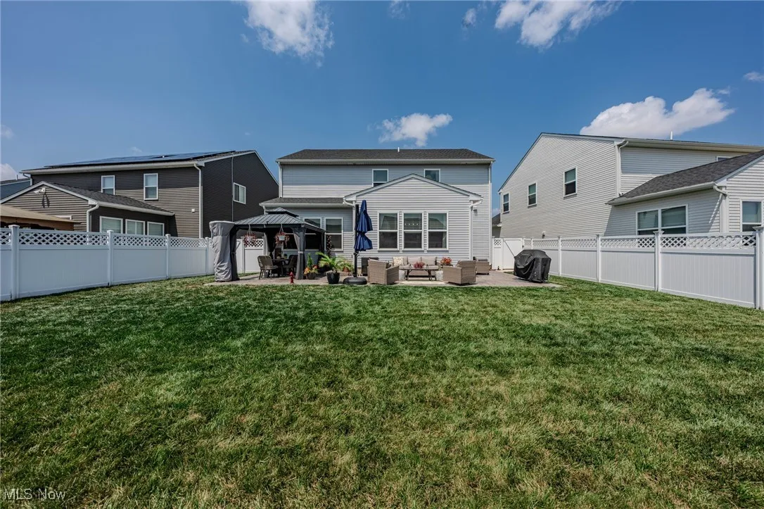 Rear view of house featuring an outdoor hangout area, a gazebo, a patio, and a fenced backyard