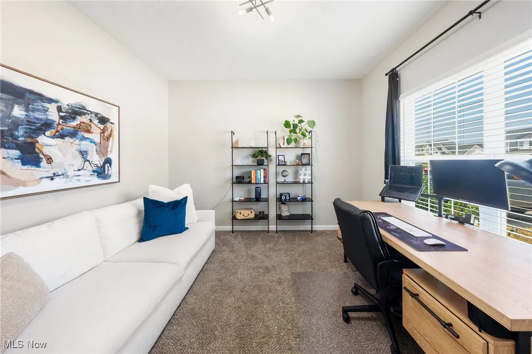 Carpeted office with baseboards