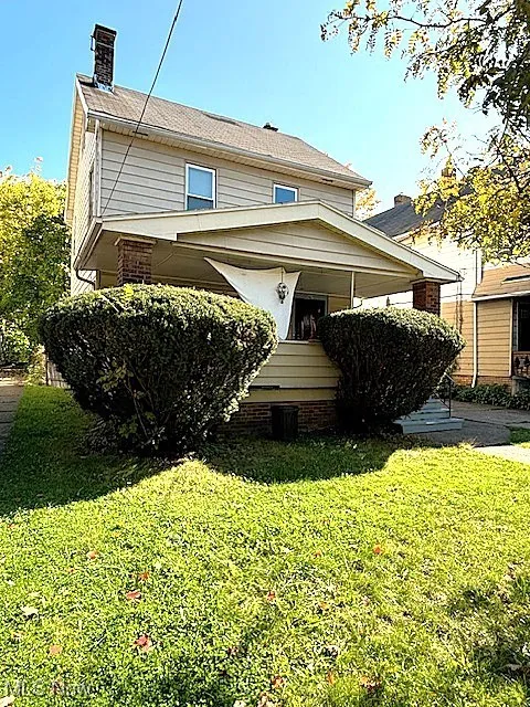 View of front of home featuring a front lawn and a chimney